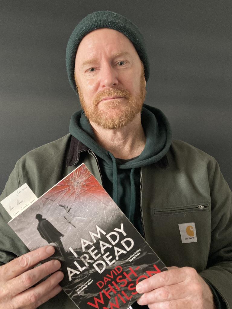 Author holding a book
